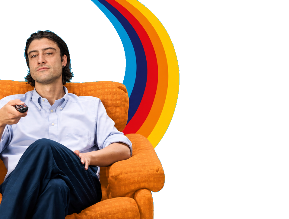 Edo on the orange armchair, holding the remote